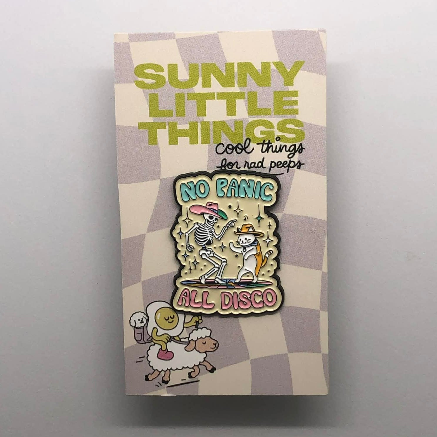 A lapel pin that says No Panic, All Disco